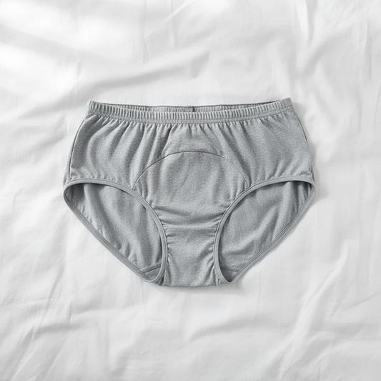 Heather Grey High Absorption Briefs flat lay on white bedding